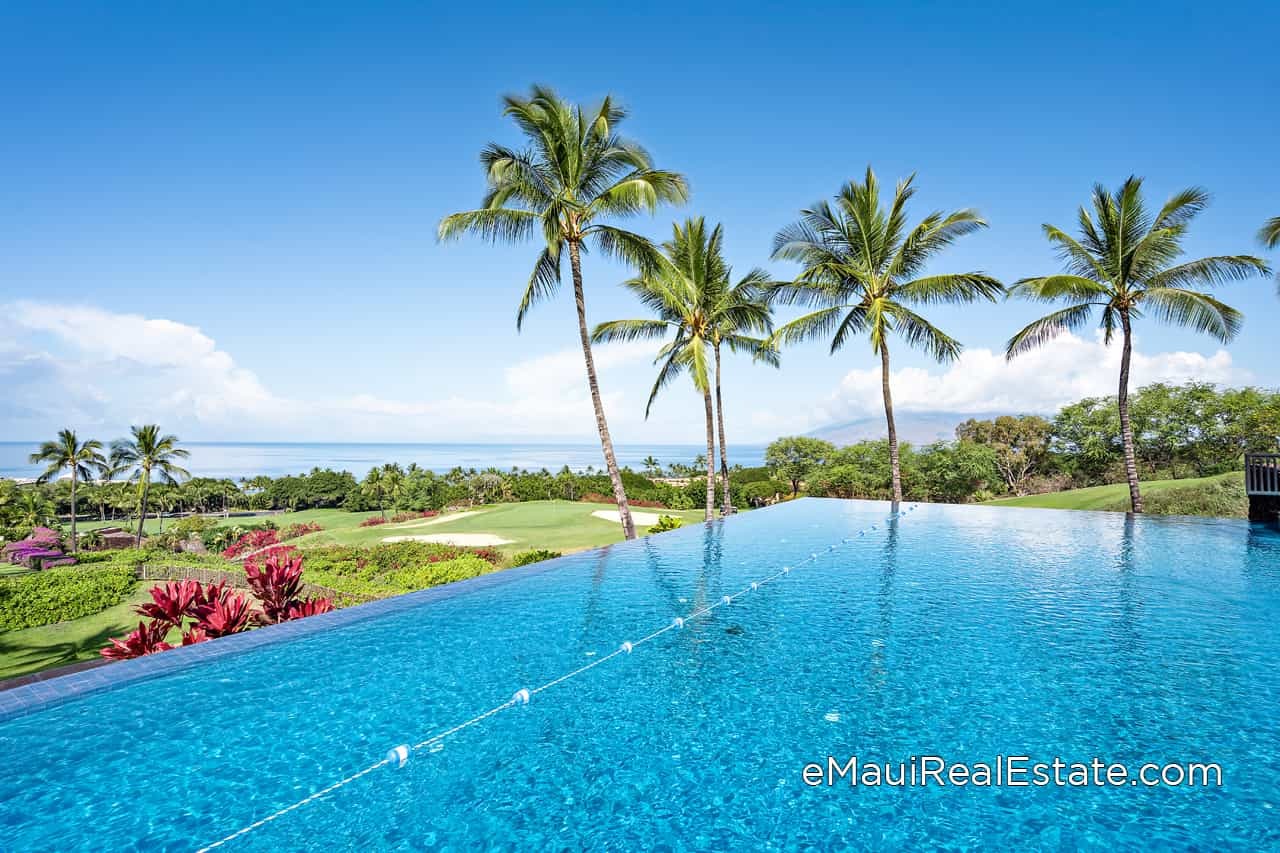 Infinity edge pool with ocean views overlooking neighboring islands